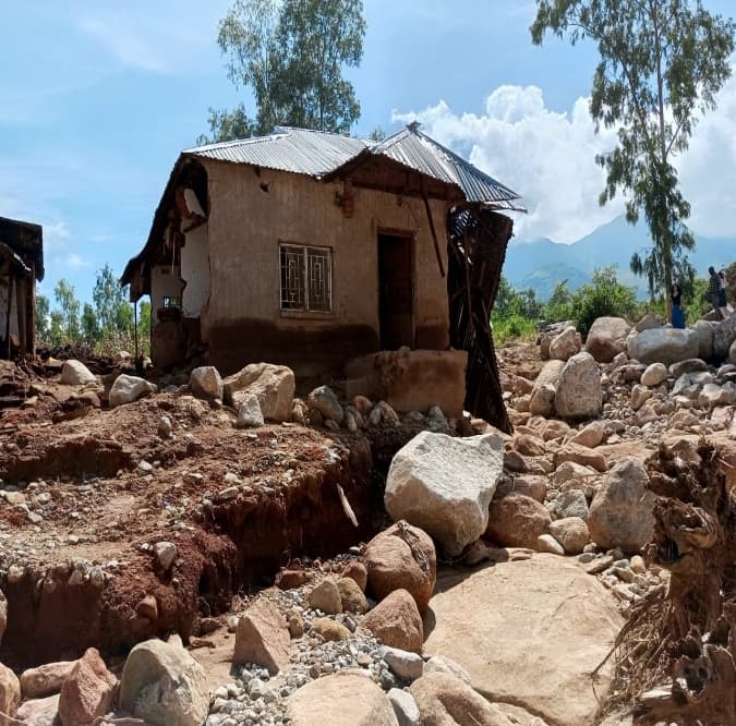 A house partially destroyed by rocks and floodwater during Cyclone Freddy
