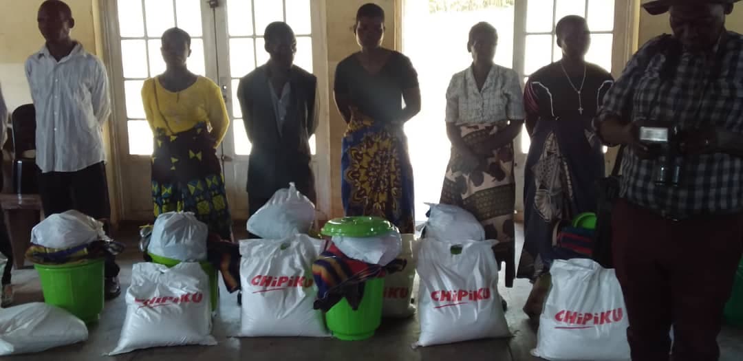 Buckets, jerry cans, and hygiene kits laid out for community distribution